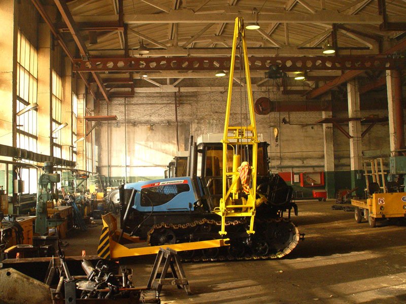 heavy equipment workshop setup with tools machinery and repair area
